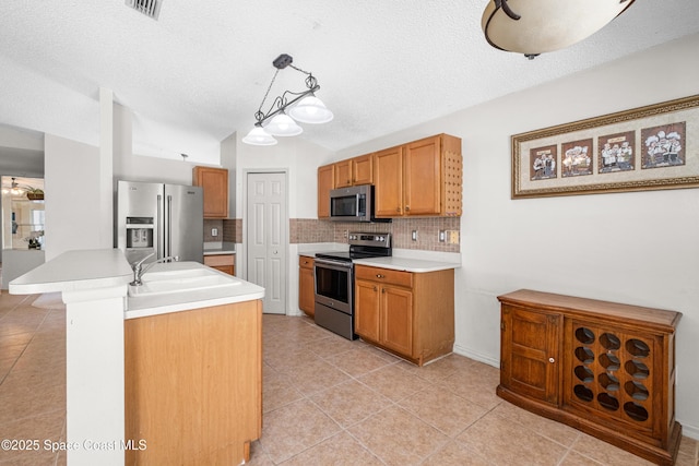 2127 Deercroft Dr, Melbourne, FL 32940 - kitchen featuring stainless steel appliances, tasteful backsplash, a textured ceiling, lofted ceiling, and light countertops