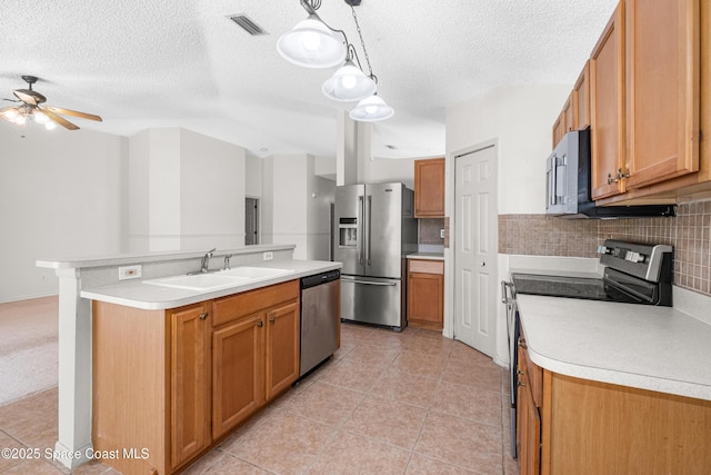2127 Deercroft Dr, Melbourne, FL 32940 - kitchen featuring stainless steel appliances, a sink, ceiling fan, light countertops, and a textured ceiling
