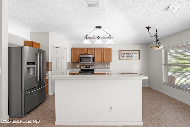 2127 Deercroft Dr, Melbourne, FL 32940 - kitchen featuring stainless steel appliances, light tile patterned flooring, light countertops, a textured ceiling, and tasteful backsplash