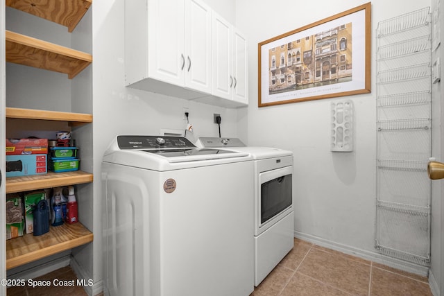 2127 Deercroft Dr, Melbourne, FL 32940 - clothes washing area with washer and clothes dryer, cabinet space, light tile patterned floors, and baseboards