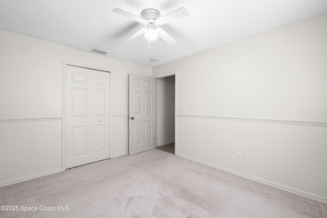2127 Deercroft Dr, Melbourne, FL 32940 - unfurnished bedroom with carpet floors, a textured ceiling, a closet, ceiling fan, and baseboards