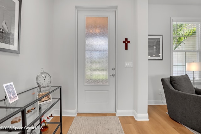 entrance foyer featuring wood finished floors and baseboards