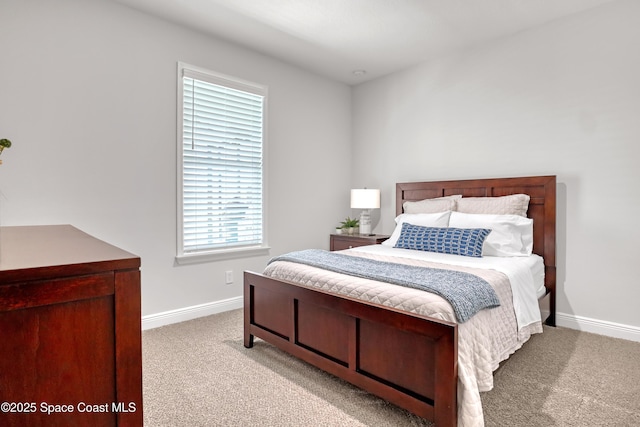 bedroom with carpet and baseboards