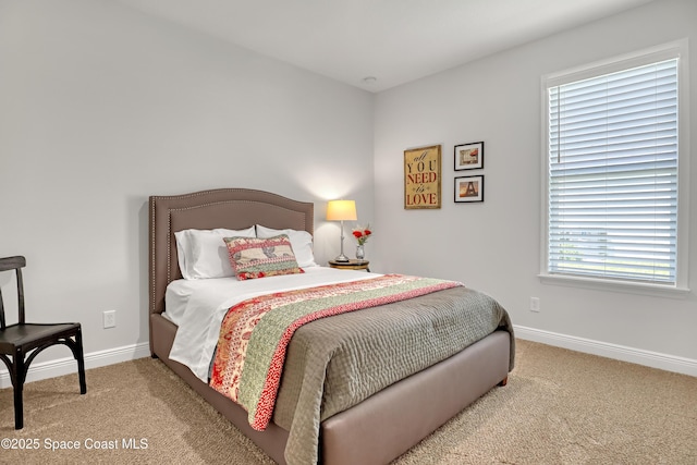carpeted bedroom featuring baseboards
