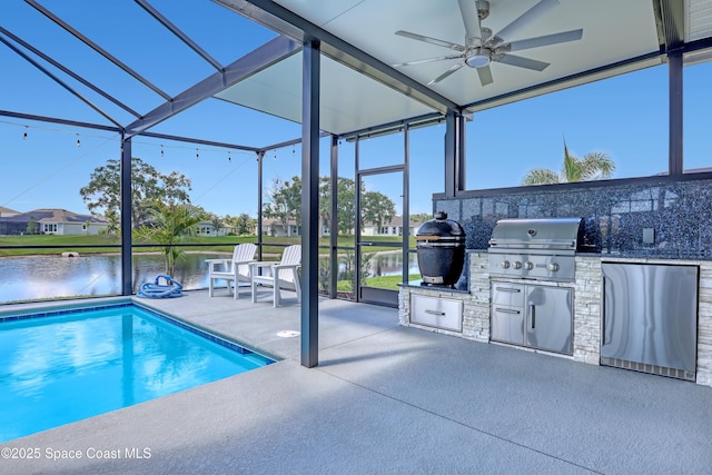 outdoor pool with an outdoor kitchen, a grill, ceiling fan, a patio area, and a water view