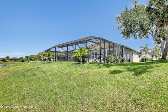 view of grassy yard featuring a lanai