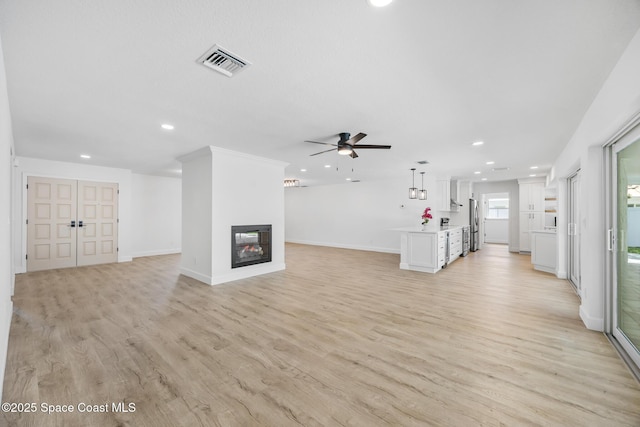 unfurnished living room with recessed lighting, ceiling fan, light wood-style flooring, baseboards, and a multi sided fireplace