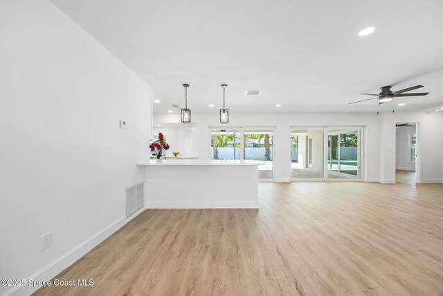 unfurnished living room with recessed lighting, light wood finished floors, baseboards, and a ceiling fan