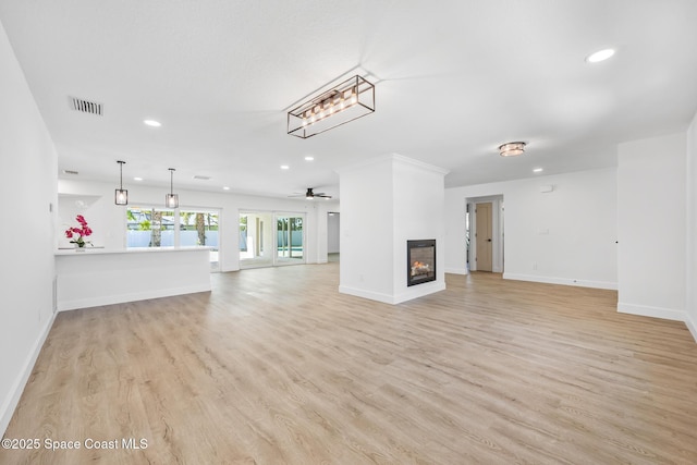 unfurnished living room with recessed lighting, light wood finished floors, a multi sided fireplace, baseboards, and a ceiling fan