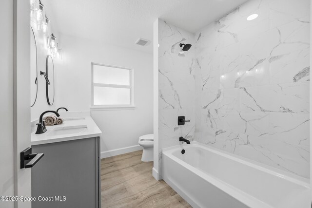 full bathroom with toilet, double vanity, baseboards, bathing tub / shower combination, and wood finished floors
