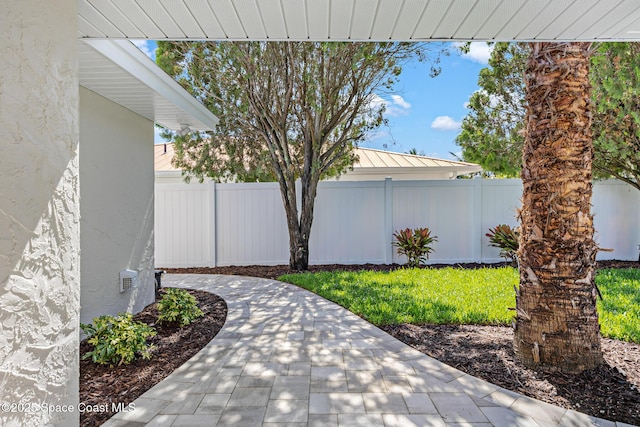 view of yard featuring fence and a patio