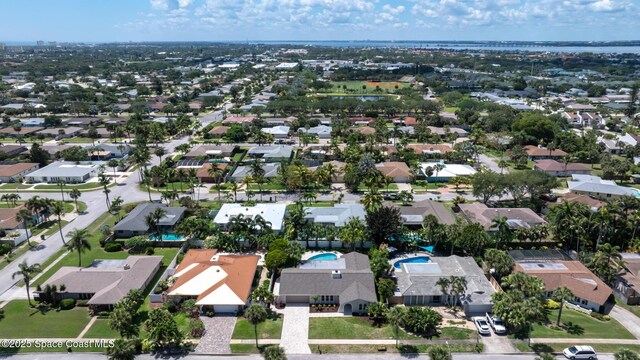 aerial view of property's location with nearby suburban area and a pool area