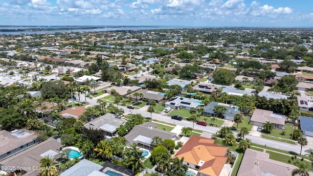 aerial view of residential area with a large body of water