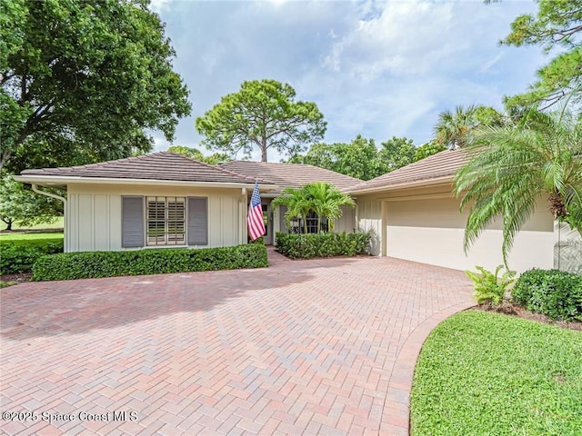single story home with a garage and decorative driveway