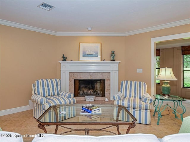 living room featuring crown molding, a fireplace, and baseboards