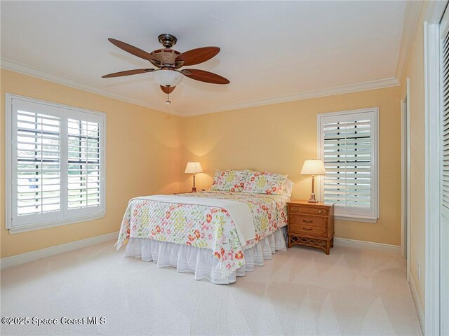 bedroom featuring baseboards, ornamental molding, carpet flooring, and a ceiling fan