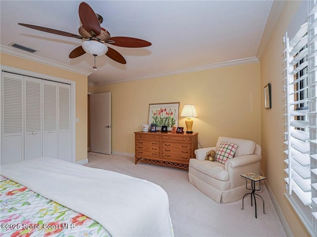 bedroom featuring light colored carpet, ornamental molding, a closet, multiple windows, and a ceiling fan
