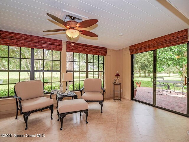 sunroom / solarium with a ceiling fan and healthy amount of natural light