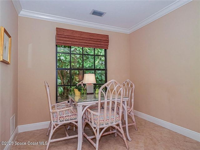 dining space featuring ornamental molding, baseboards, and light tile patterned floors