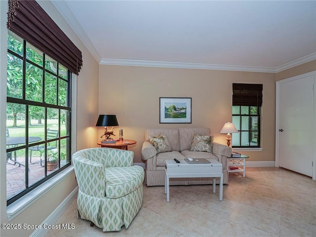 living area featuring crown molding, baseboards, and light tile patterned flooring