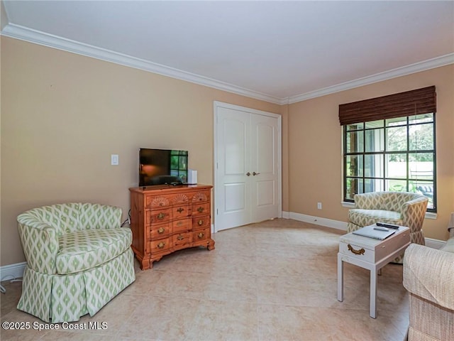 sitting room with crown molding and baseboards