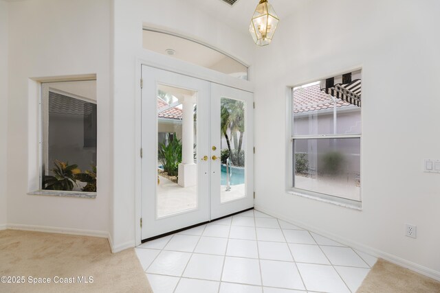 7433 Monterey Ct, Melbourne, FL 32940 - doorway to outside featuring french doors, carpet floors, and baseboards
