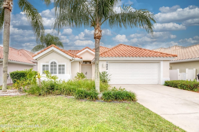 7433 Monterey Ct, Melbourne, FL 32940 - mediterranean / spanish home with stucco siding, a garage, concrete driveway, a front lawn, and a tile roof