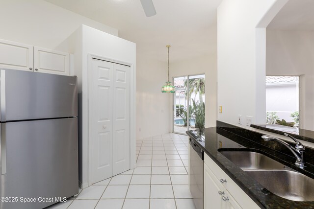 7433 Monterey Ct, Melbourne, FL 32940 - kitchen with appliances with stainless steel finishes, white cabinets, a sink, dark stone counters, and pendant lighting