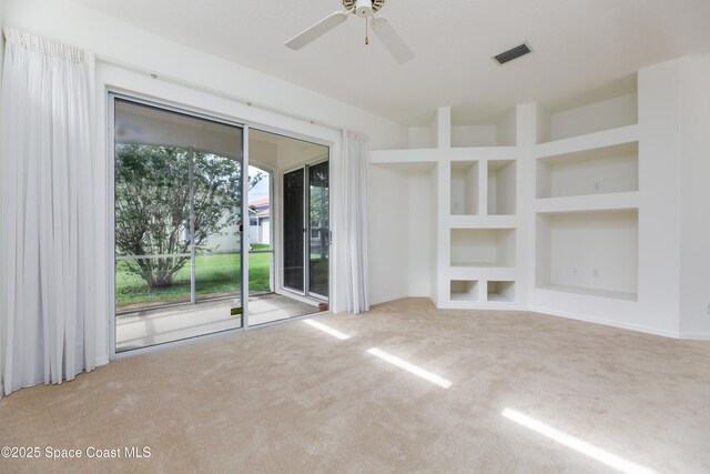 7433 Monterey Ct, Melbourne, FL 32940 - unfurnished living room featuring carpet floors, built in features, and a ceiling fan