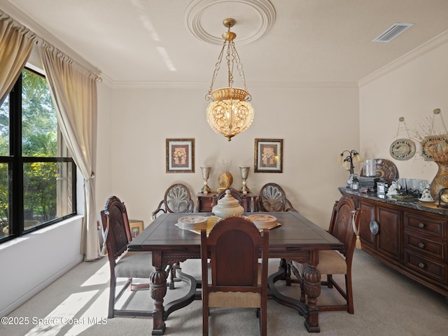 1013 Balmoral Way, Melbourne, FL 32940 - dining area with light colored carpet, ornamental molding, and a chandelier