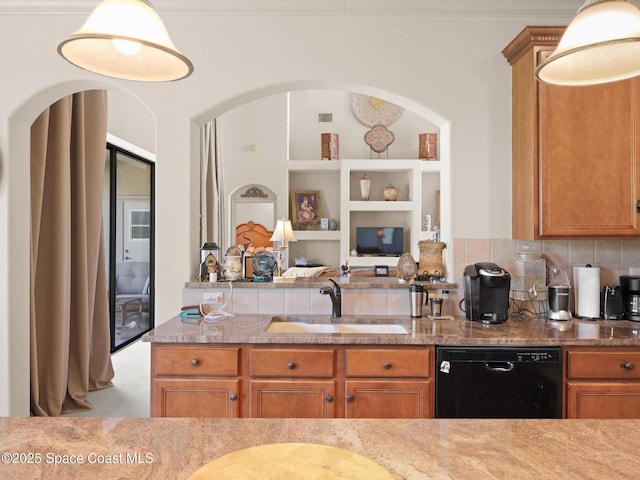 1013 Balmoral Way, Melbourne, FL 32940 - kitchen with black dishwasher, a sink, arched walkways, open floor plan, and brown cabinets