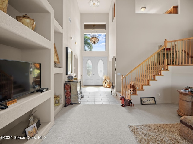 1013 Balmoral Way, Melbourne, FL 32940 - carpeted entrance foyer with a high ceiling, stairs, and tile patterned floors