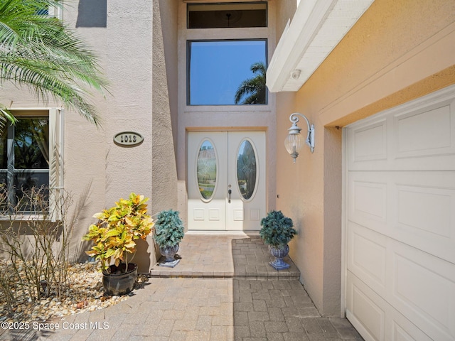 1013 Balmoral Way, Melbourne, FL 32940 - entrance to property featuring stucco siding, french doors, and an attached garage