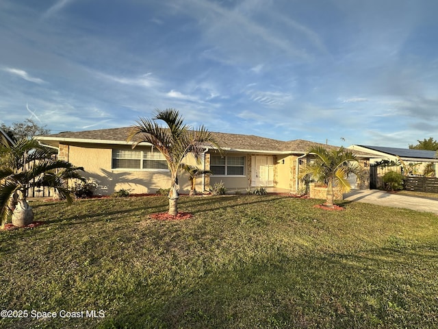 ranch-style house featuring stucco siding, concrete driveway, and a carport