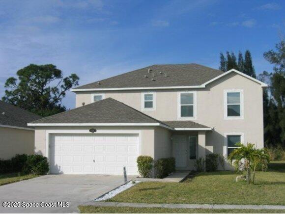 1823 Sorento Cir, Melbourne, FL 32904 - traditional-style home featuring stucco siding, a garage, driveway, a front lawn, and roof with shingles