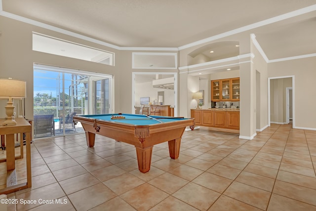 recreation room featuring light tile patterned floors, ornamental molding, billiards table, and a high ceiling