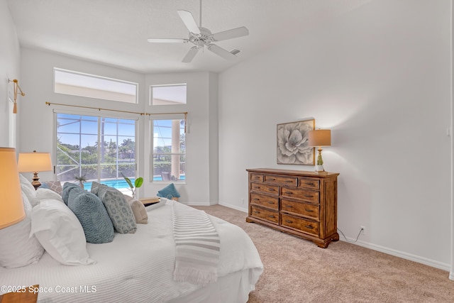 carpeted bedroom featuring baseboards and ceiling fan