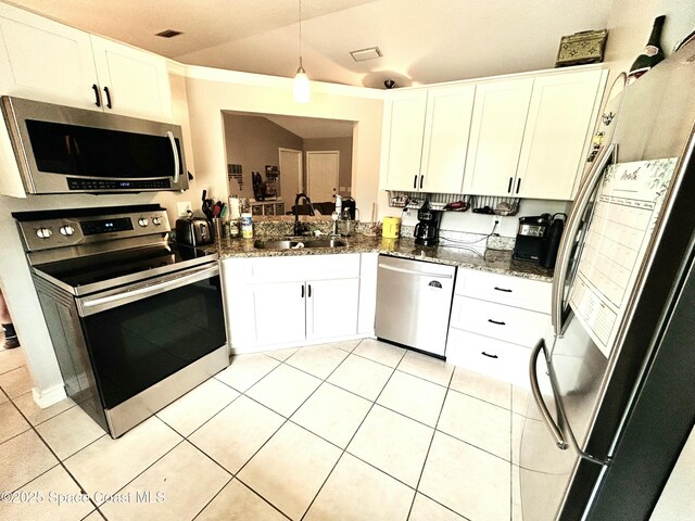 164 Bayamo Ave NE, Palm Bay, FL 32907 - kitchen with stainless steel appliances, a sink, white cabinetry, and light tile patterned floors