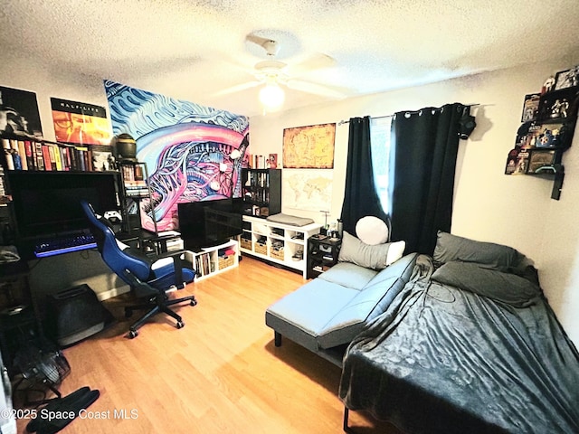 164 Bayamo Ave NE, Palm Bay, FL 32907 - bedroom with a textured ceiling, wood finished floors, a desk, and ceiling fan