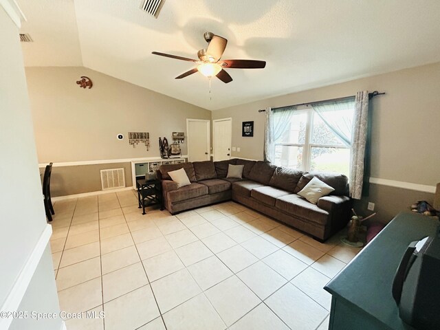164 Bayamo Ave NE, Palm Bay, FL 32907 - living area featuring a ceiling fan, light tile patterned flooring, and lofted ceiling