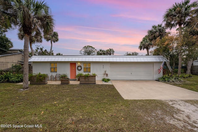 847 W Virginia St, Cocoa, FL 32927 - view of front of house with driveway, an attached garage, and a yard