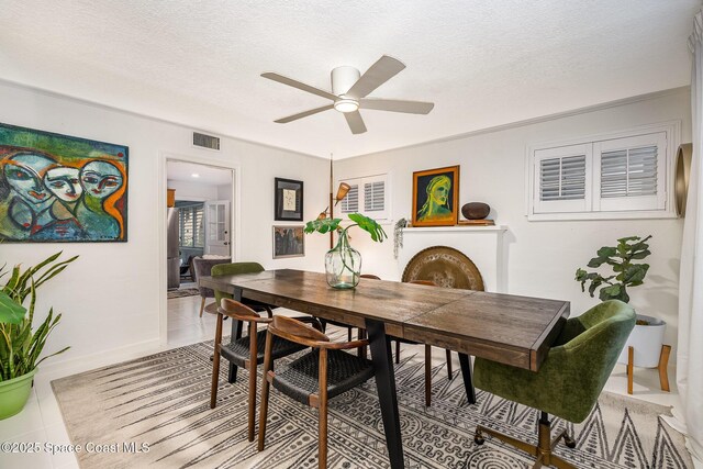 847 W Virginia St, Cocoa, FL 32927 - dining room with a ceiling fan, a textured ceiling, and baseboards