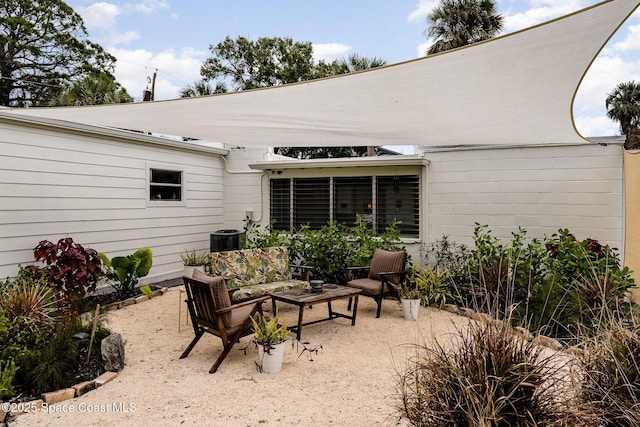 847 W Virginia St, Cocoa, FL 32927 - view of patio featuring central AC and an outdoor hangout area