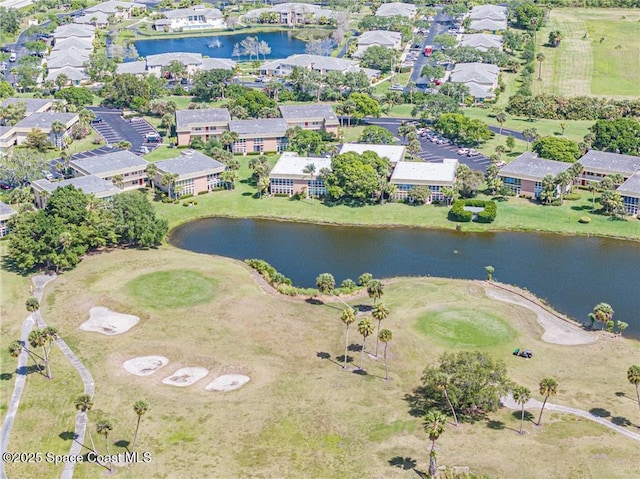 aerial view of property and surrounding area featuring a local golf course, a large body of water, and nearby suburban area