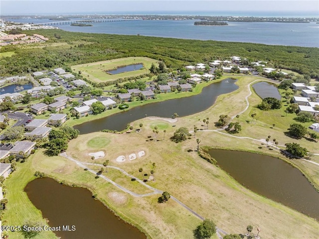 aerial overview of property's location with a nearby body of water, nearby suburban area, and a golf course