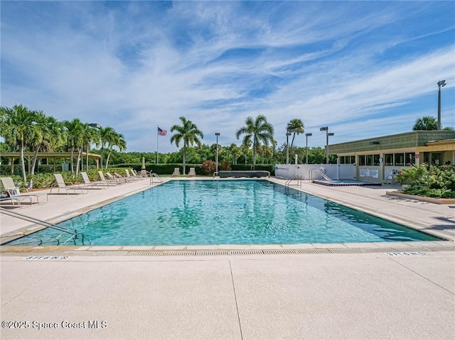 community pool with a patio area