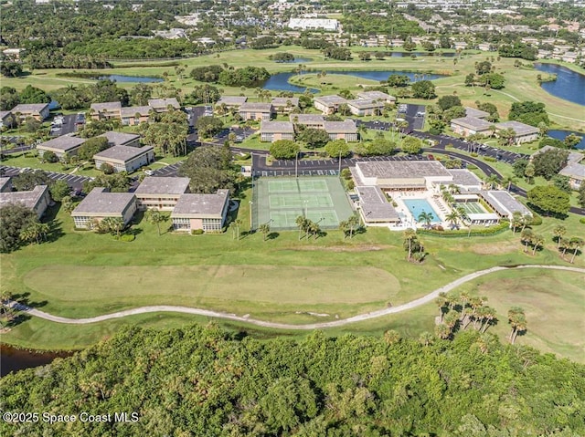 aerial view of property's location with a nearby body of water, a golf club, and nearby suburban area