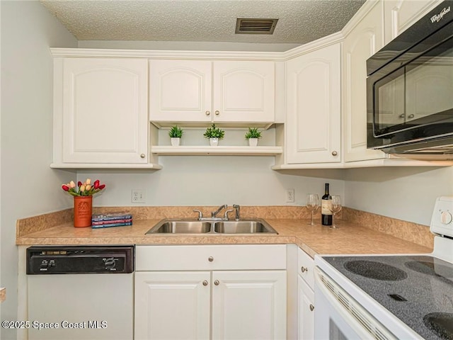 kitchen featuring white appliances, a sink, open shelves, white cabinetry, and a textured ceiling