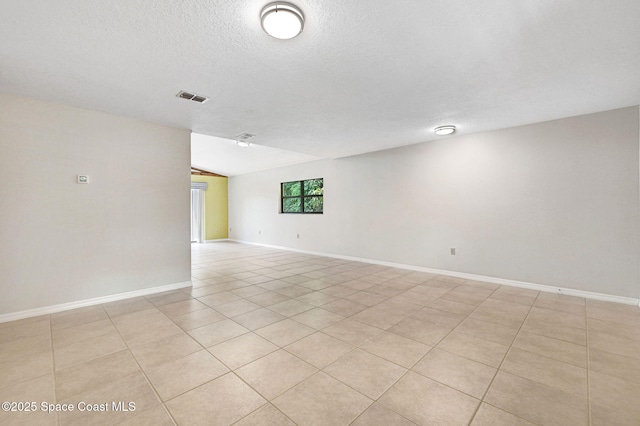 1600 Woodland Dr Unit 4206, Rockledge, FL 32955 - spare room with light tile patterned floors, a textured ceiling, and baseboards