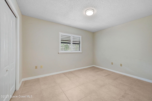 1600 Woodland Dr Unit 4206, Rockledge, FL 32955 - spare room featuring a textured ceiling, baseboards, and light tile patterned floors